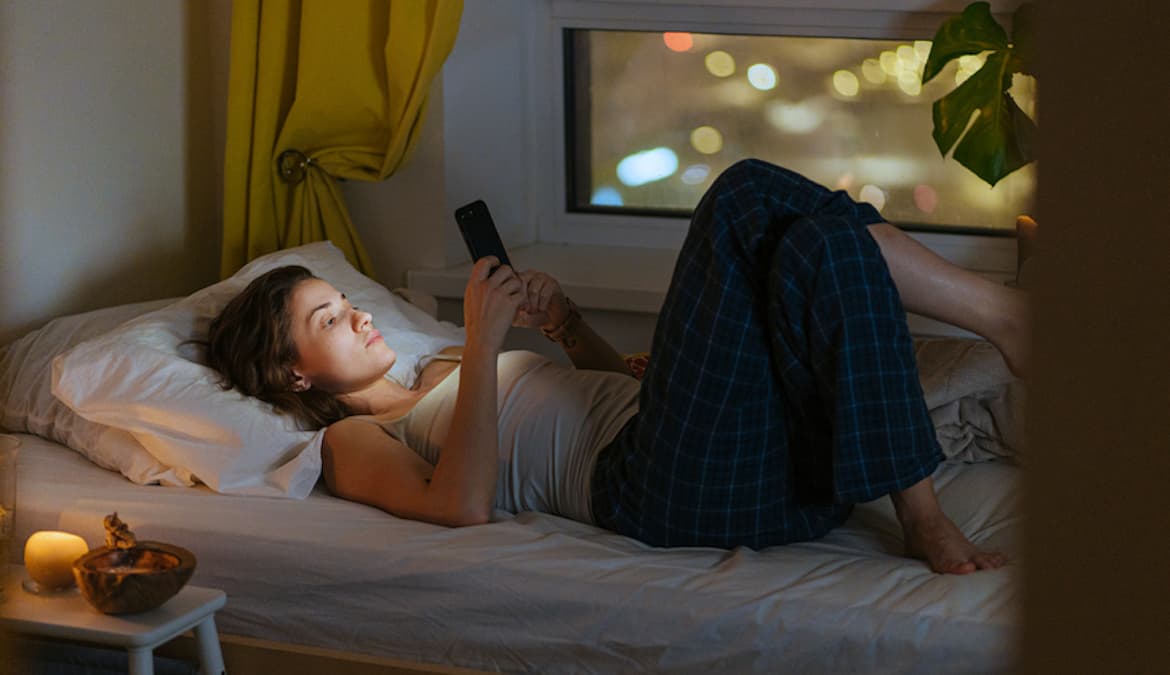 Featured image for Why You Can’t Stop Scrolling on Your Phone Before Bed, and How To Break the Pattern