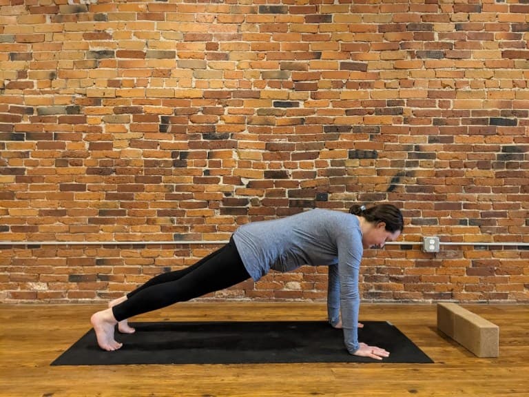 Pregnant person demonstrating high plank pose