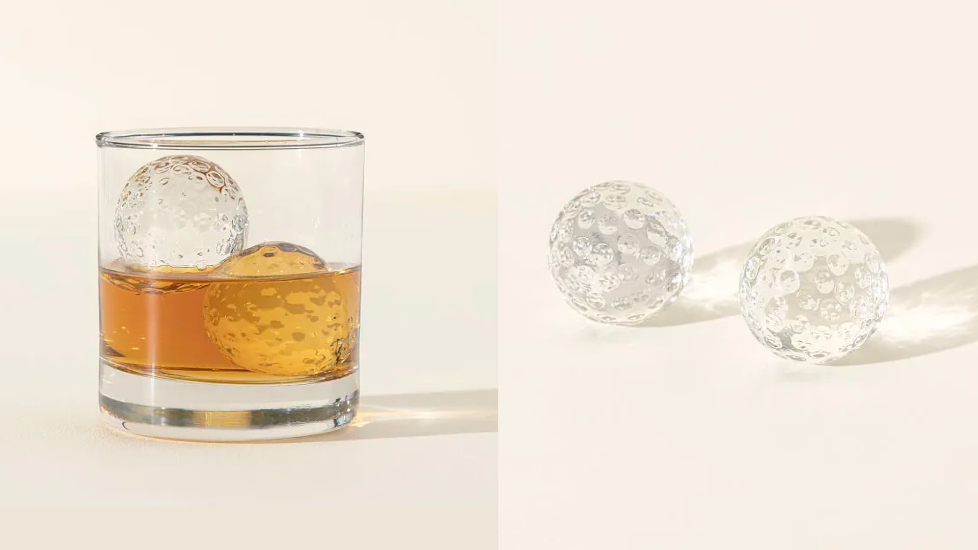 A set of two golf ball-shaped whiskey chillers. 