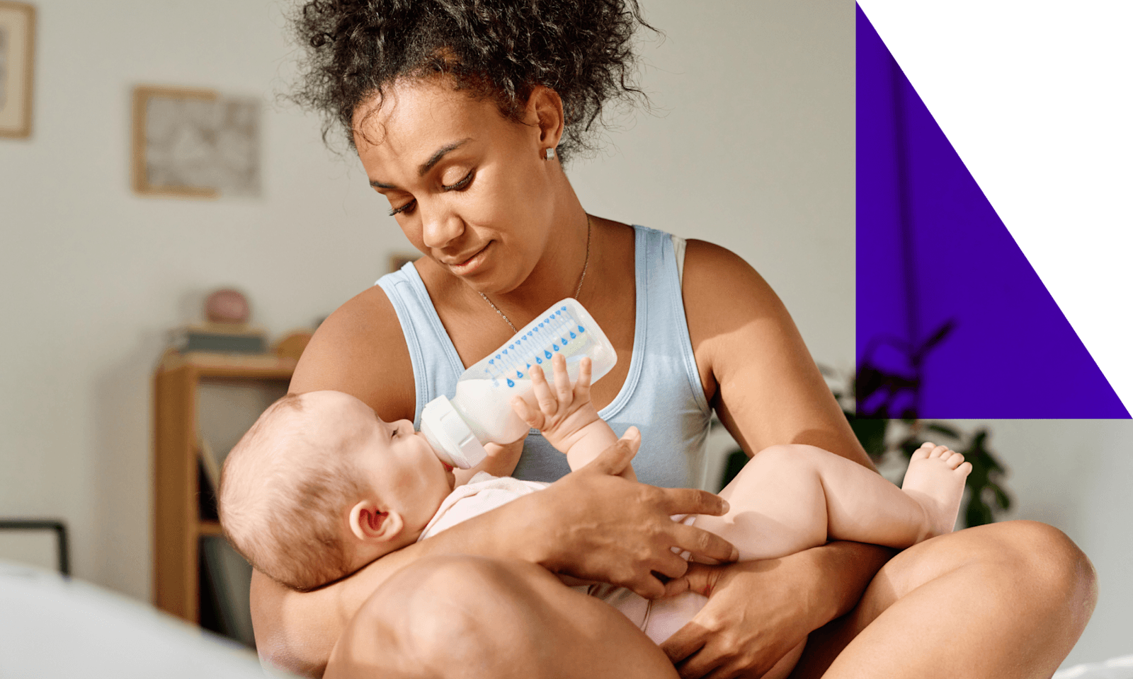 Image of a mother holding a baby with a bottle