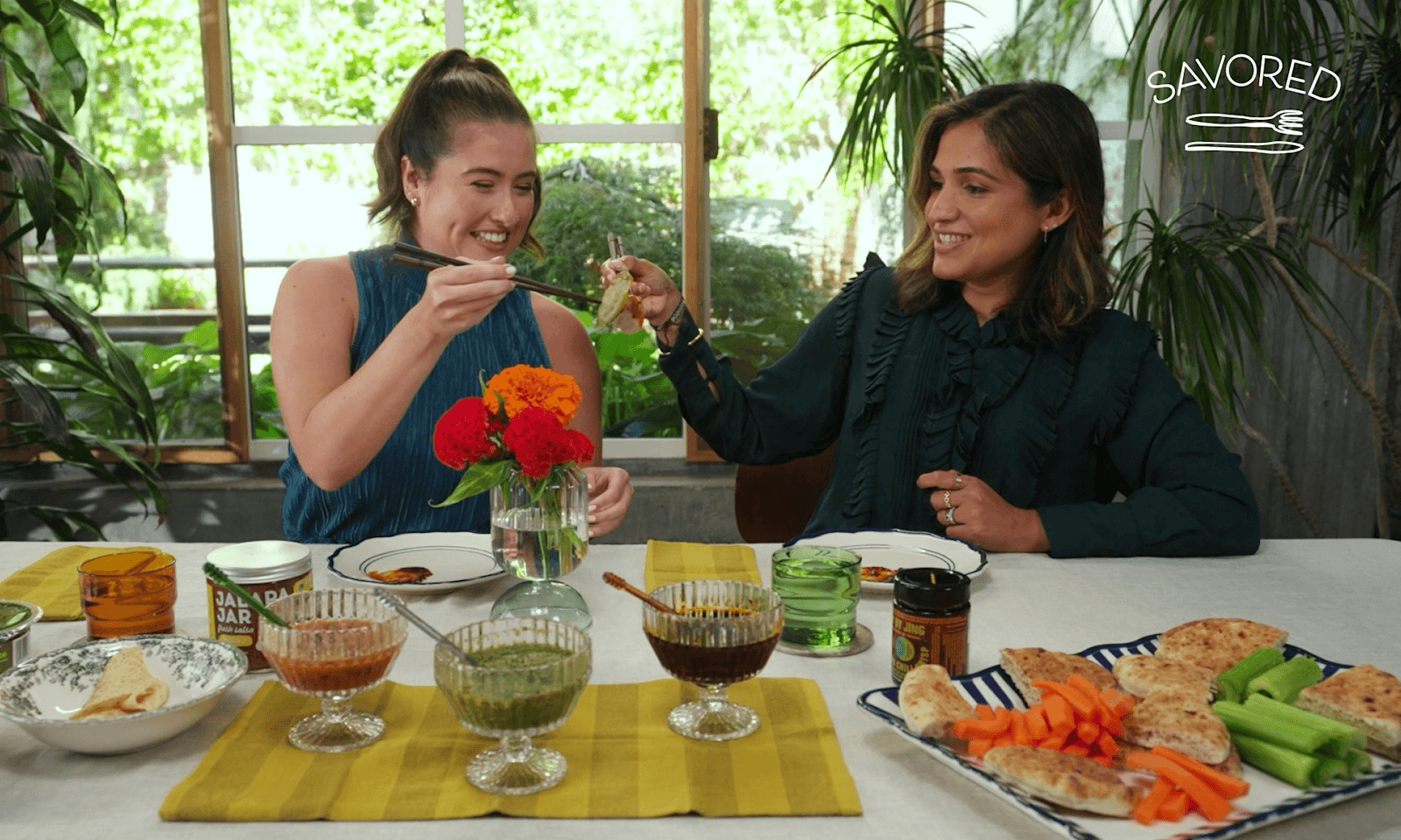 two women toasting with dumplings