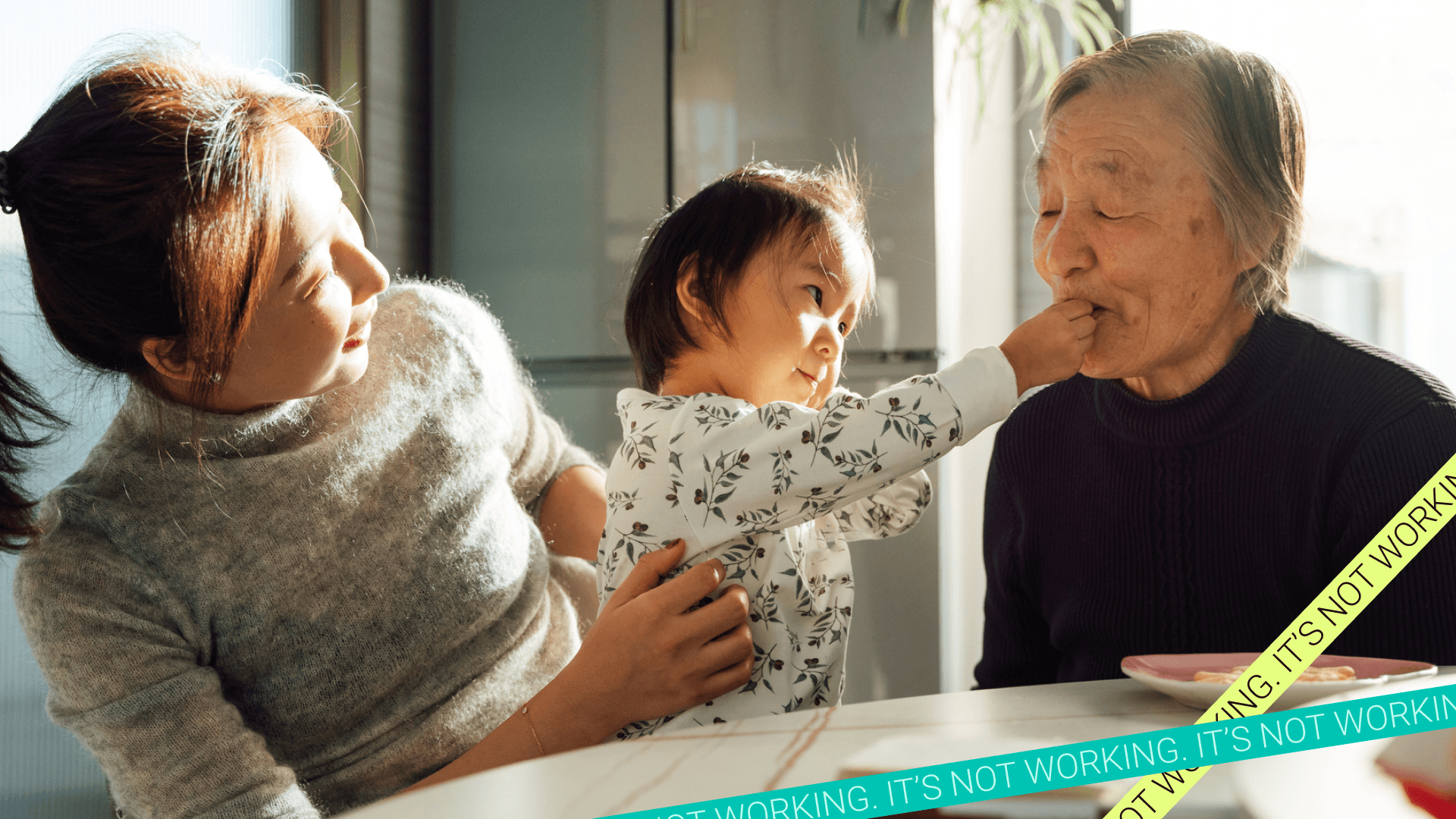 Millennial woman sits with toddler and elderly woman at kitchen table. Millennials have aged into the sandwich generation, and caregiving can threaten their financial futures.