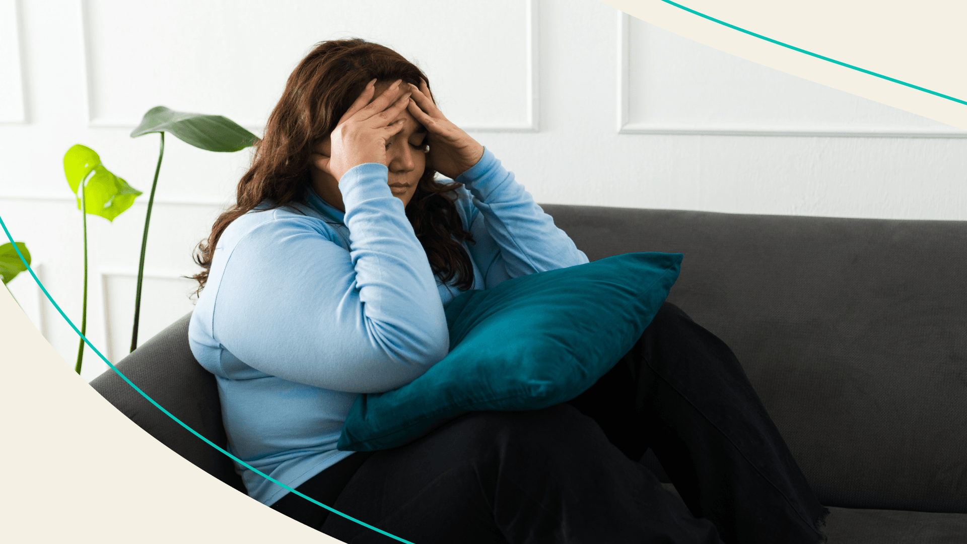 Woman sitting on the couch with her head in her hands
