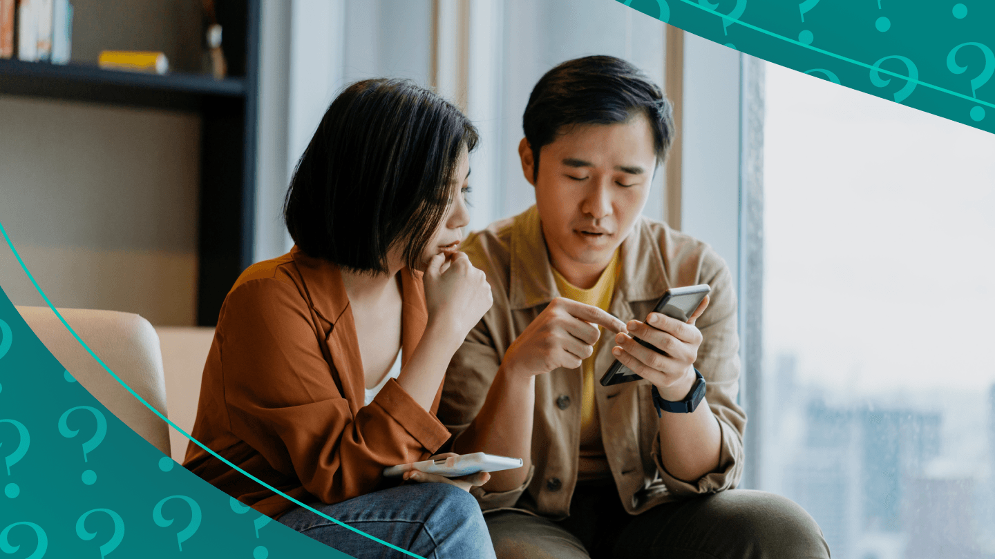 Man and woman discuss the content they're seeing on a phone.