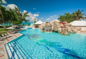 A pool with cabanas near by