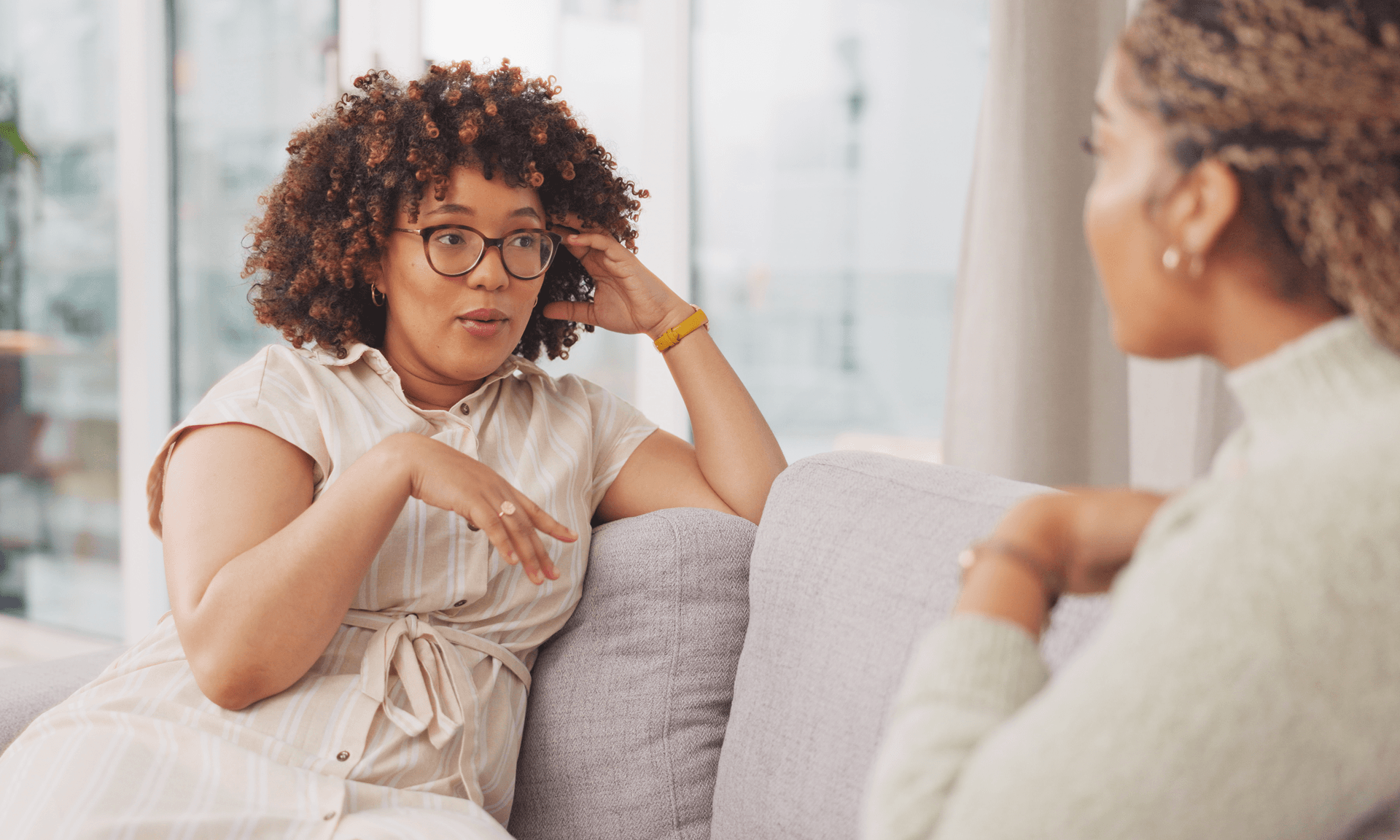 Two women talking on couch