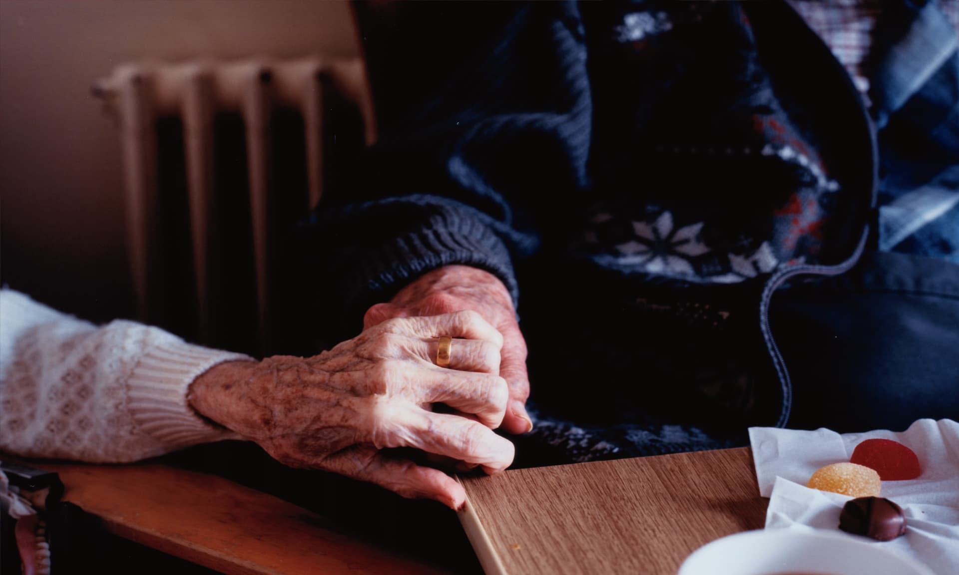 elderly couple holding hands