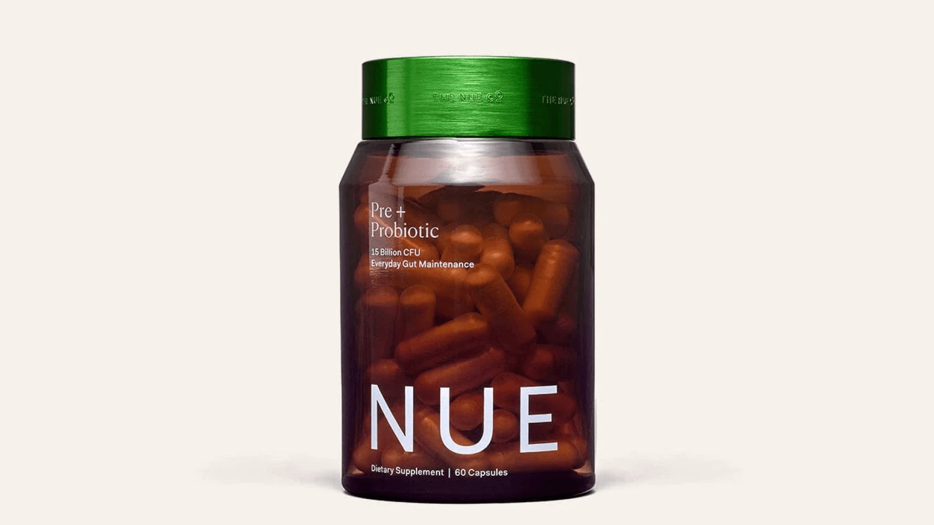 Opaque brown glass jar with green lid of probiotic capsules