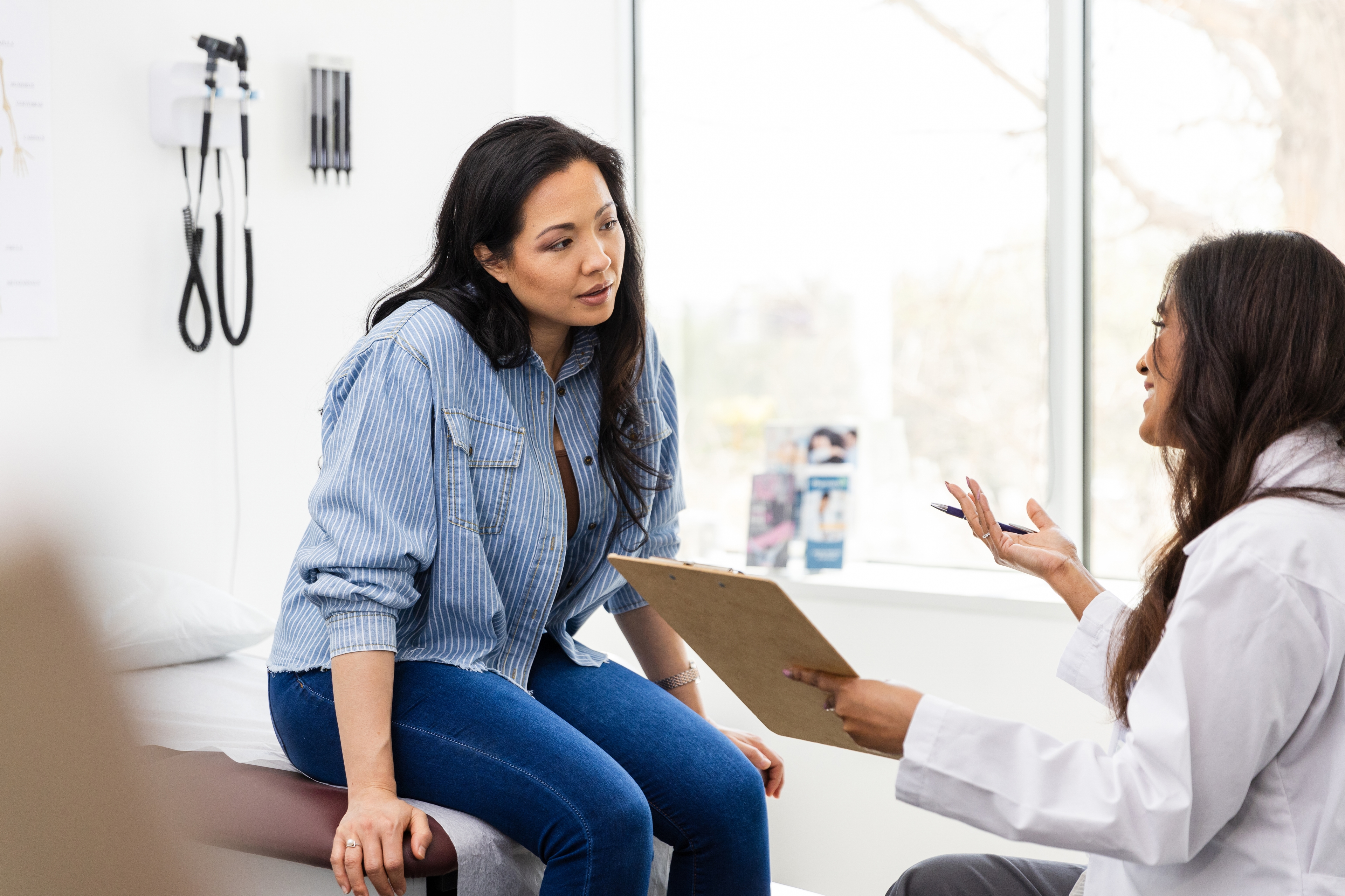 Woman talking to doctor at fertility clinic