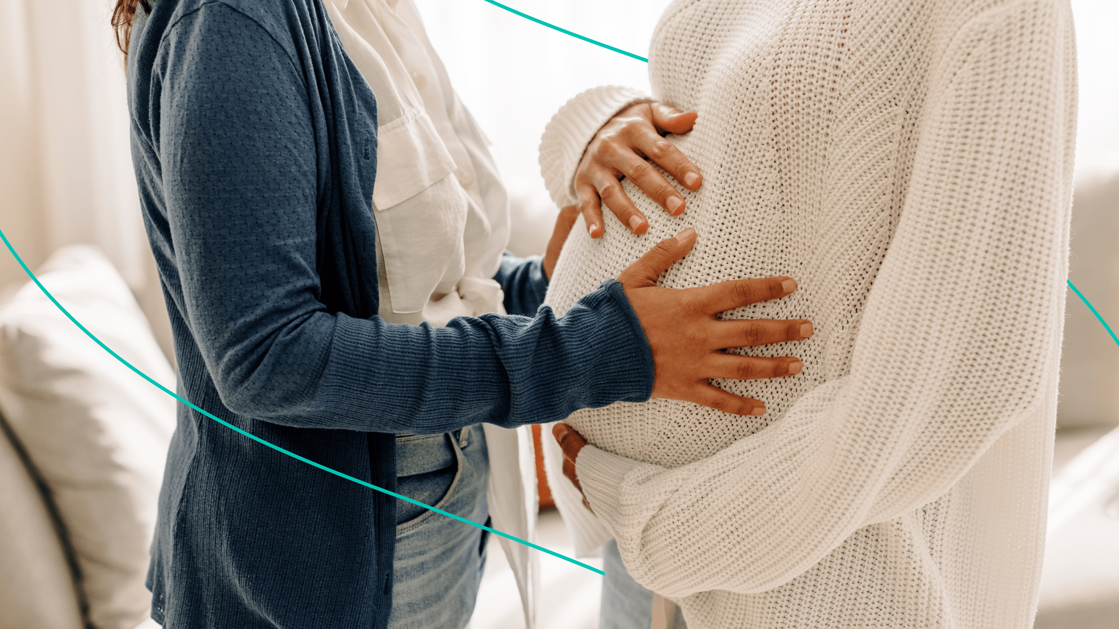 Two people cradle a pregnant person's belly