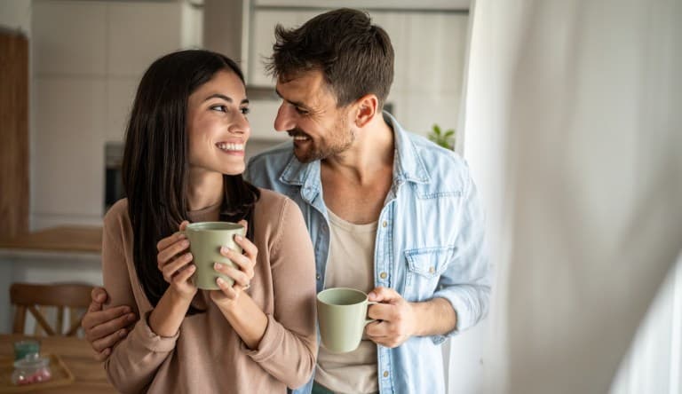Young couple looking through the window in their home; parent reminds me of my partner