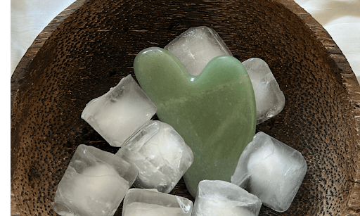 gua sha in bowl of ice cubes