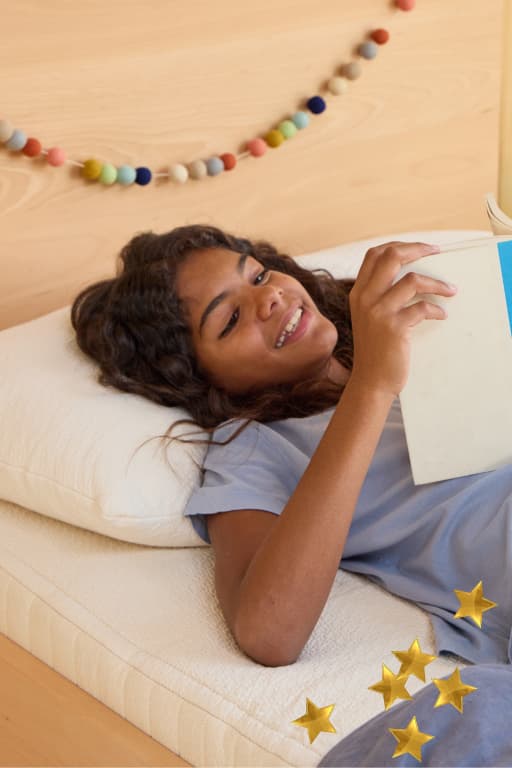 child reading on a bed