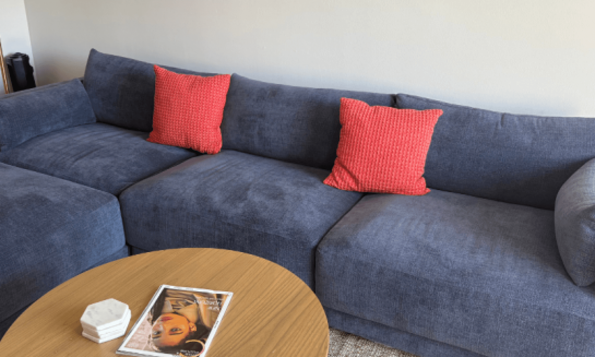 Blue sofa with red accent pillow