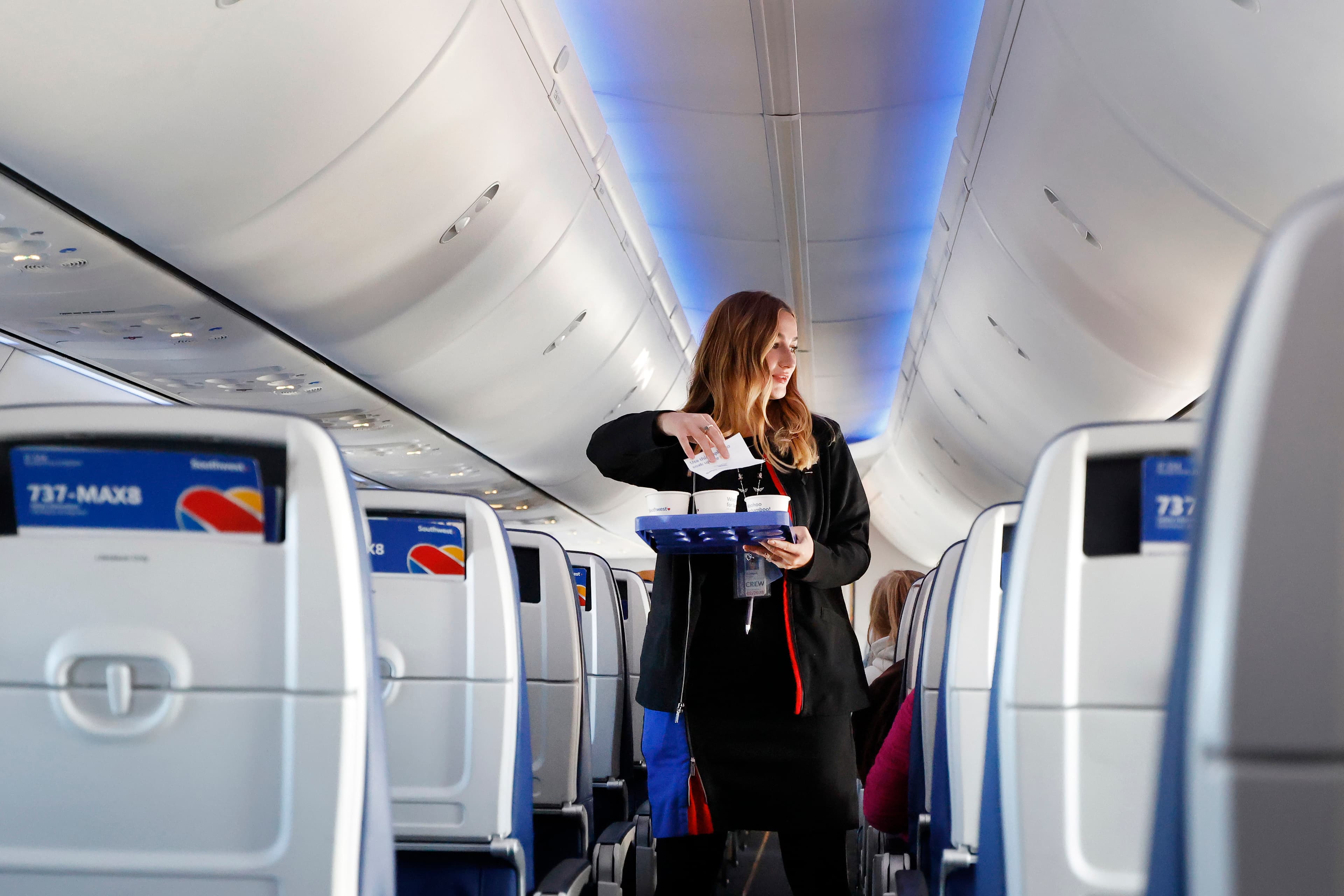 Flight attendant distributes brochures